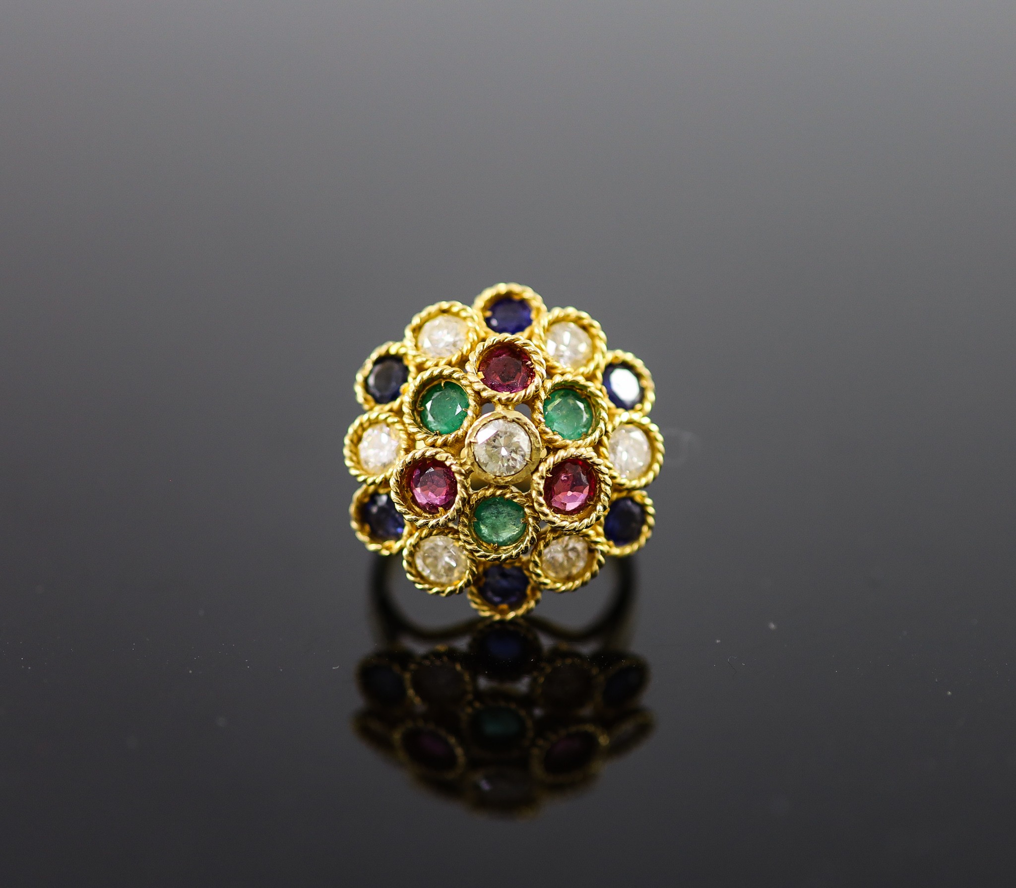 A continental gold (stamped 850) and multi gem set circular dress ring